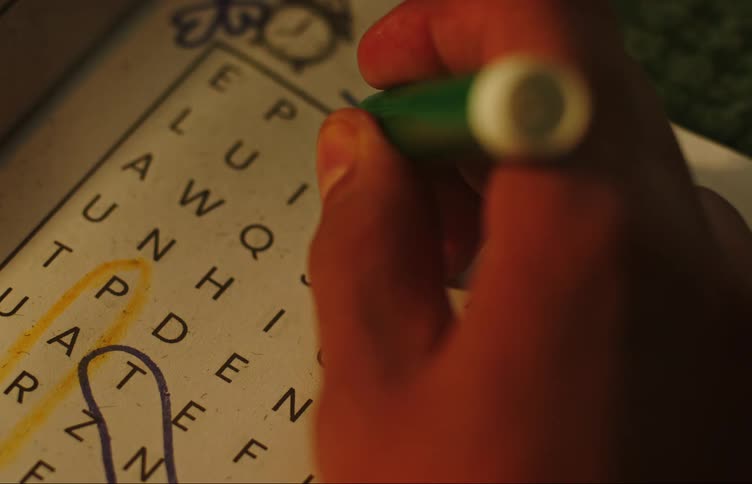 A person solving a crossword puzzle