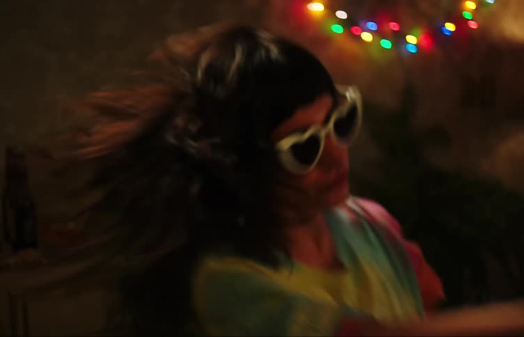 Female teenager dances in room at night