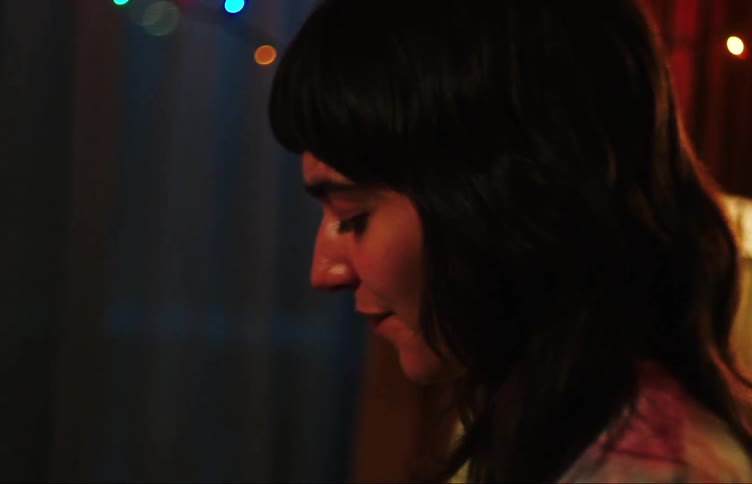 Two young women having fun while dancing in the room at night