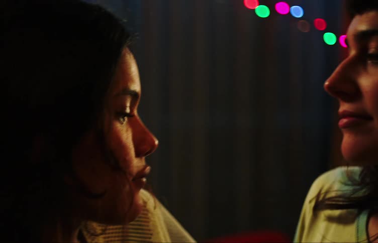 Two young women dancing together in an intimate way