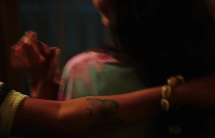 Two young women in a room dancing together in an intimate manner
