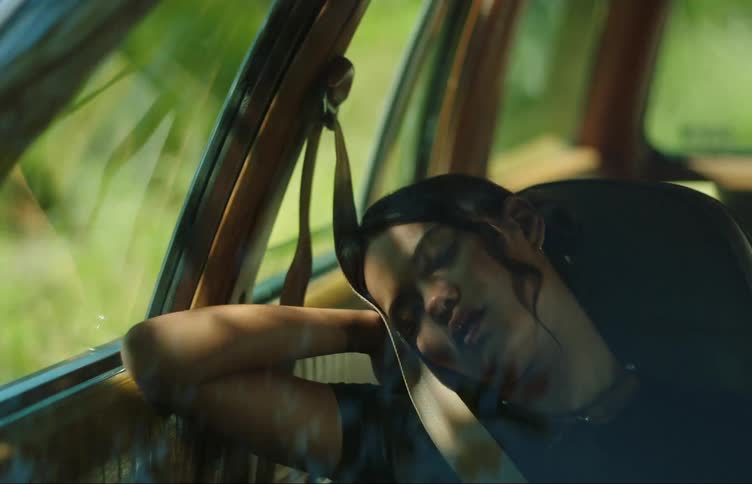 A teenage girl sleeping on the passenger seat of a car