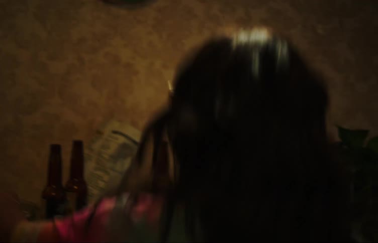 A young woman puts on glasses two women dance and drink beer