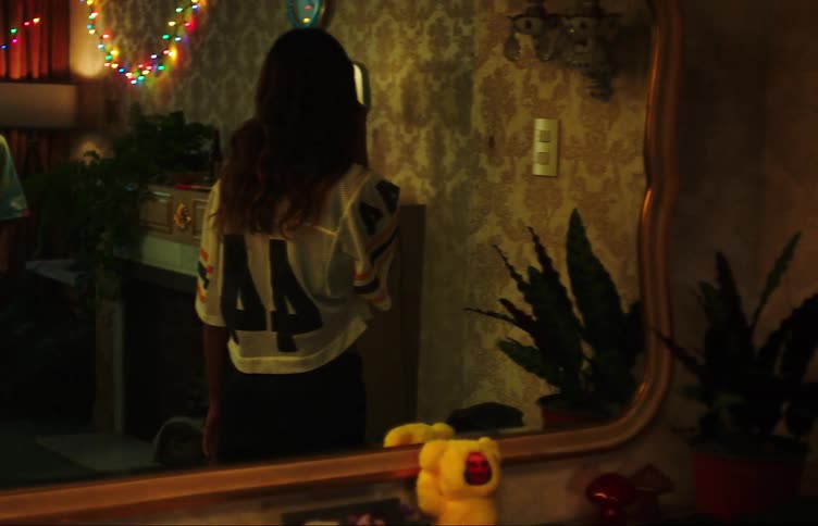 Two teenage girls kiss before saying goodbye