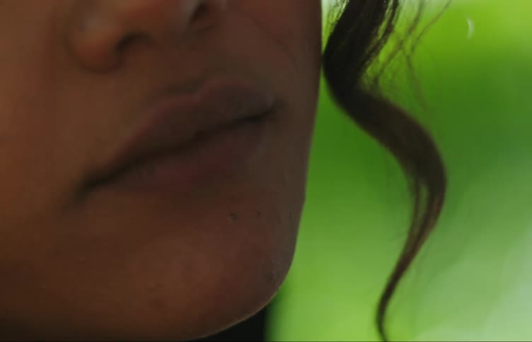Closeup of a young womans mouth smoking