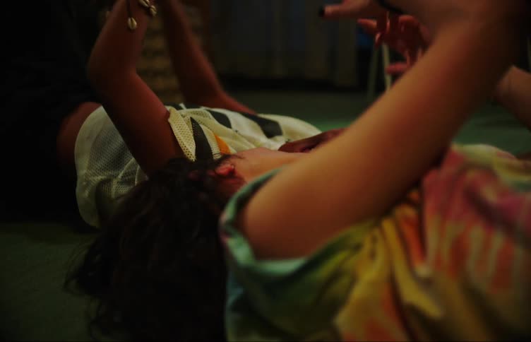 Teenage girls lying on the floor playing with their hands while dancing and smiling