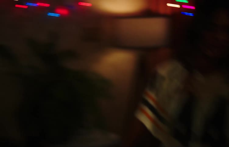 Two young friends dancing and jumping in the living room at night