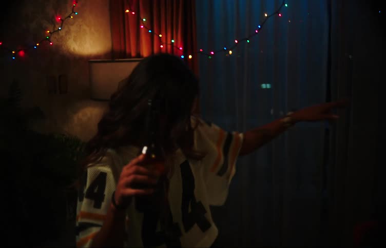 Two friends drink beer while dancing
