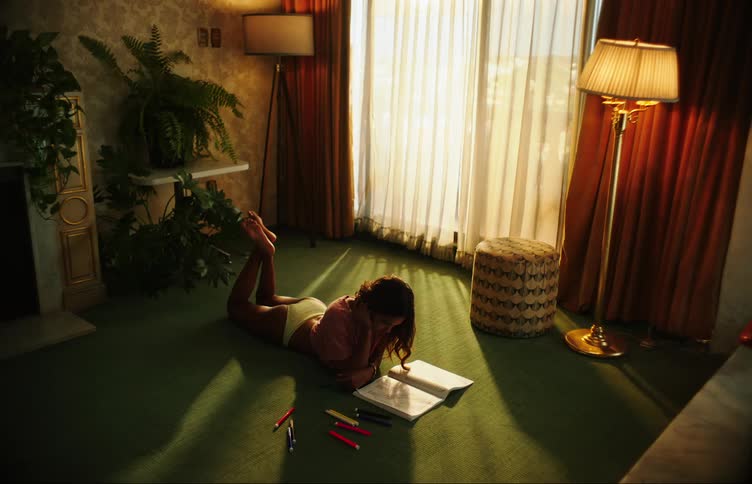 A lady laying on the floor and studying