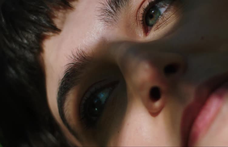 Close up of the face of a teenage girl under a tree