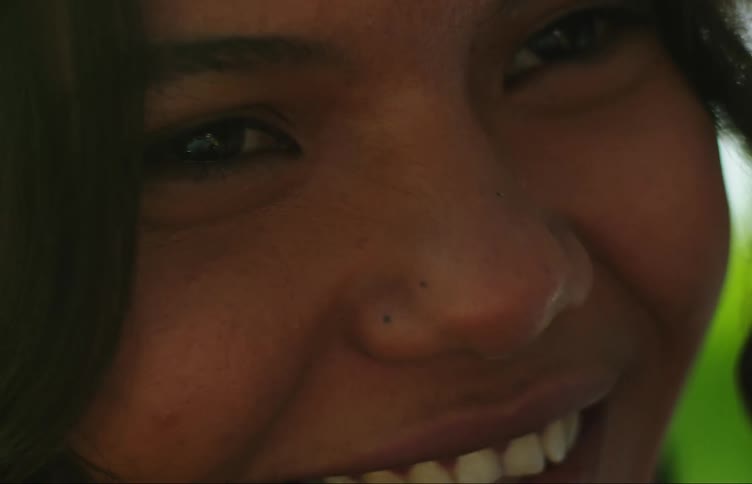 Close up of the face of a young woman sticking her tongue out