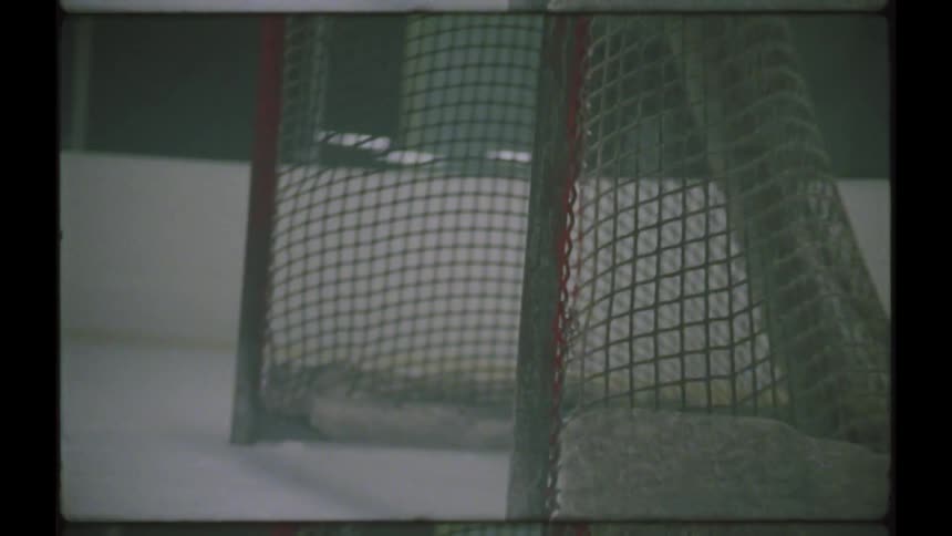 A hockey player practicing shots to the goal