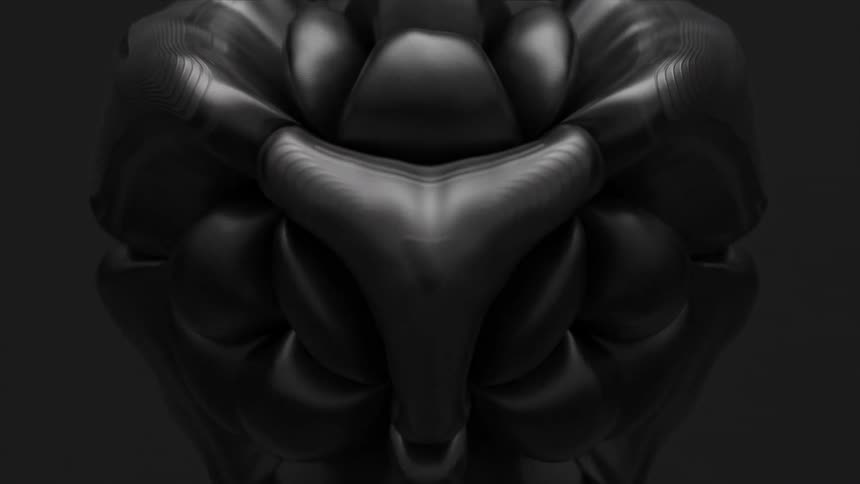 A black soccer ball inflates and distorts against a black background