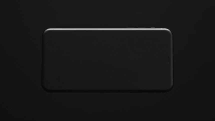 A black smartphone spins and zooms to the camera