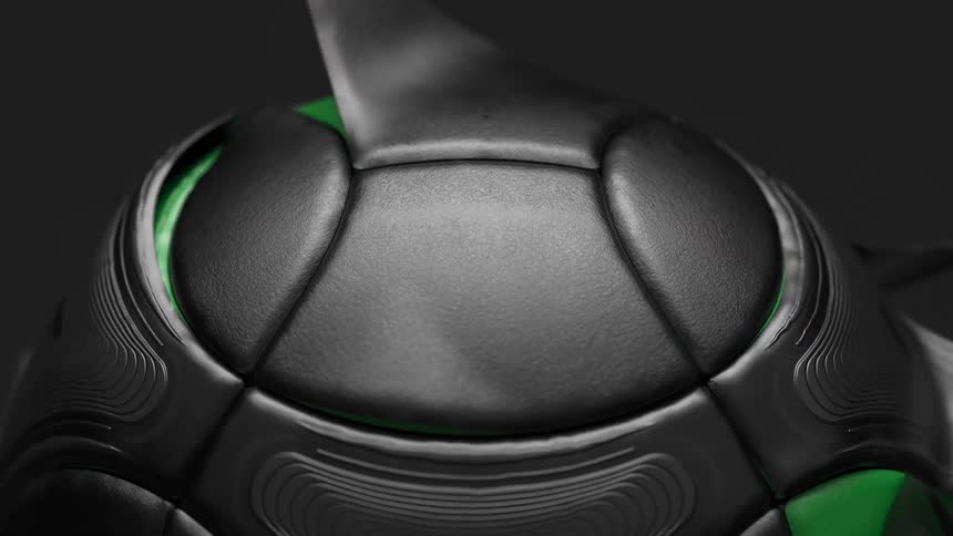 Black pentagons peel from a green soccer ball