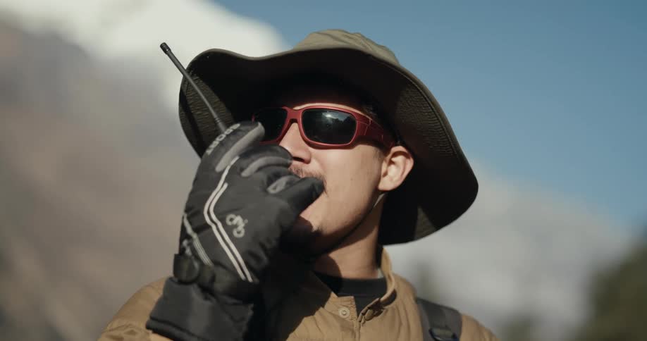 Portrait of a man communicating by radio while in a natural environment