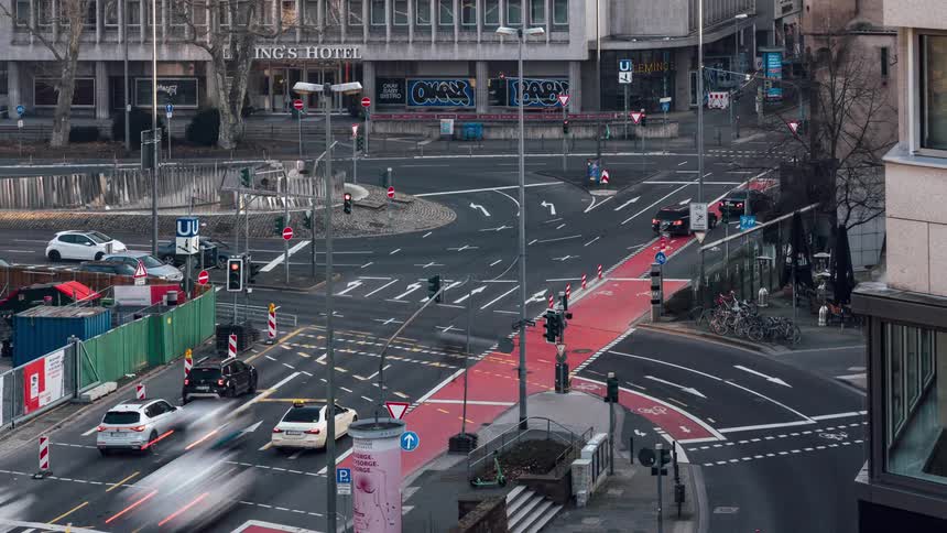 Time lapse of vehicles driving on a busy intersection in the city