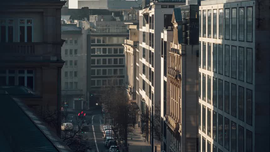Metropolises with commercial and urban buildings and a street with vehicle and pedestrian traffic in timelapse