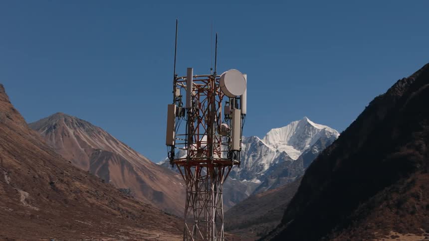 Signal transmission tower located in a natural environment with mountains around