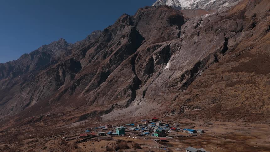 Panorama of a village on a plateau next to mountains in winter