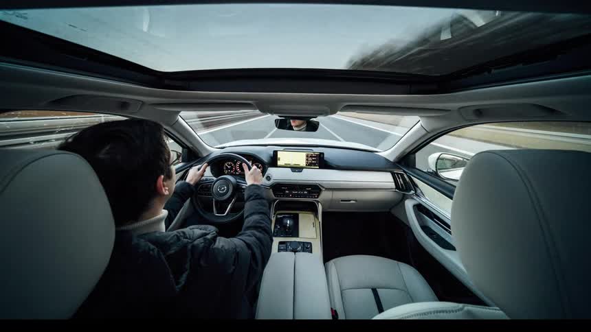 Interior panorama of a man driving a vehicle with a panoramic roof down a highway in timelapse