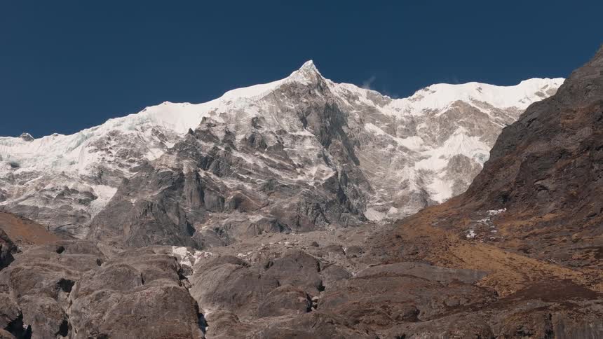 Aerial scenery of peaks and mountains with snow on a cloudless blue sky day