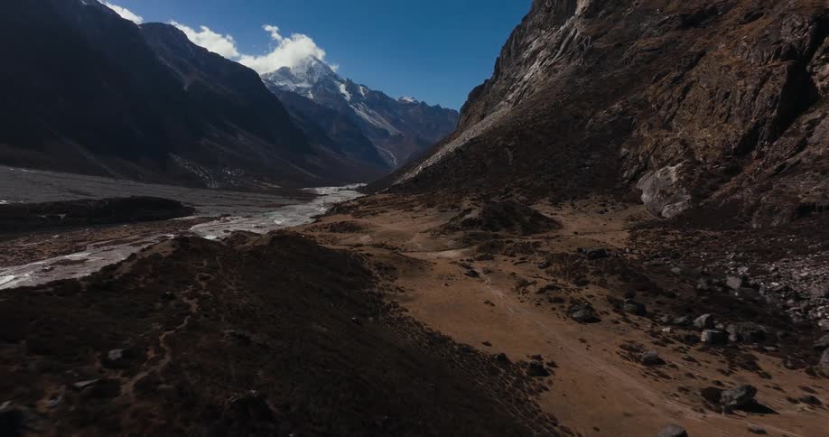A small tall formation in a mountainous region with a valley to the left
