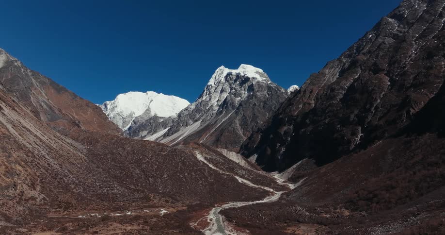 Forward moving shot through a canyon a visible mountain range in the distance