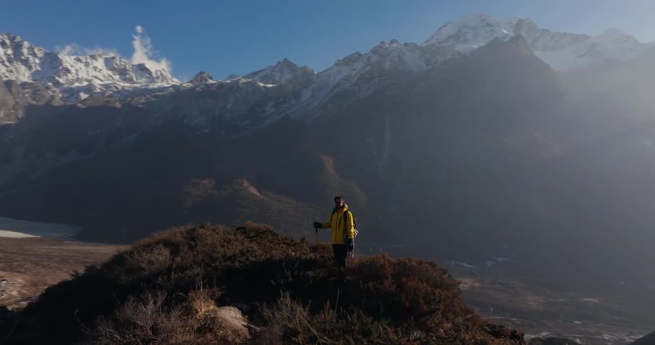 A hiker standing at the top of a mountain