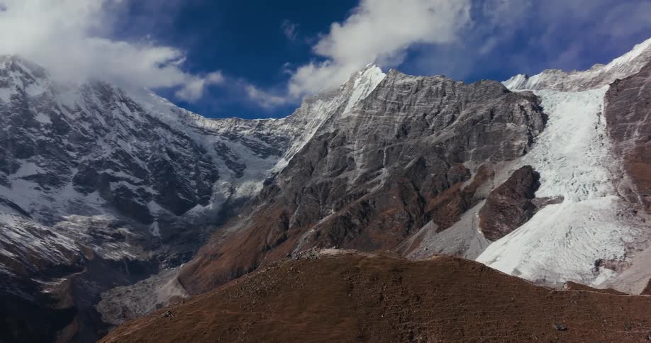 Aerial scenery of cliffs and rock deformities of snowy mountains