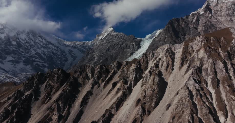 A mountainous area with huge closed information and snow on top of some mountains