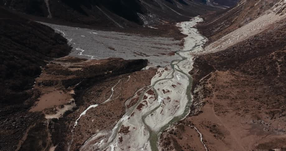 A frozen river bed in a rocky valley