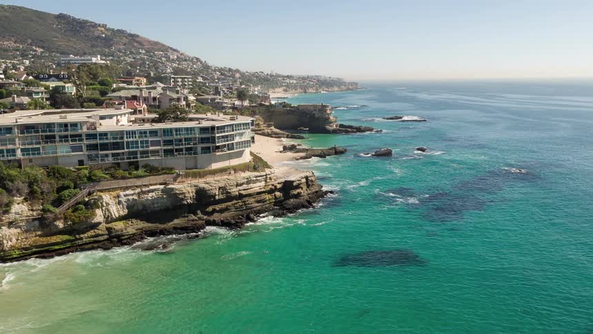 A photo of a hotel on a cliff overlooking the ocean