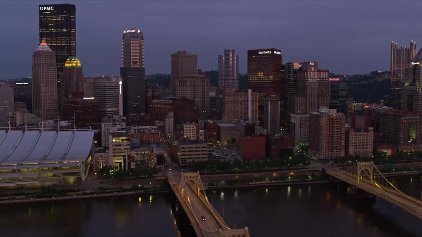 Aerial panorama of a metropolis with a river canal and bridges connecting it to commercial buildings in a purple sky