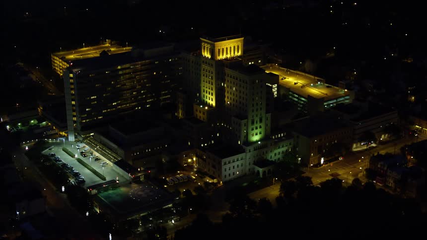 Aerial panorama of a metropolis at night with buildings