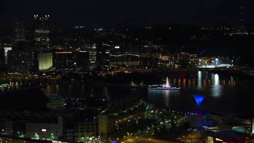 Cars drive through the city at night