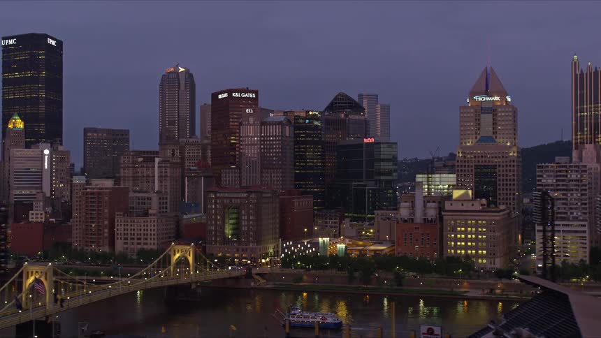Cars drive by river near the city