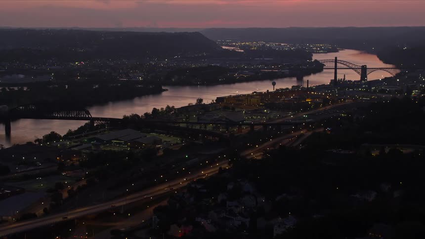 Cars move through a city at dawn or dusk