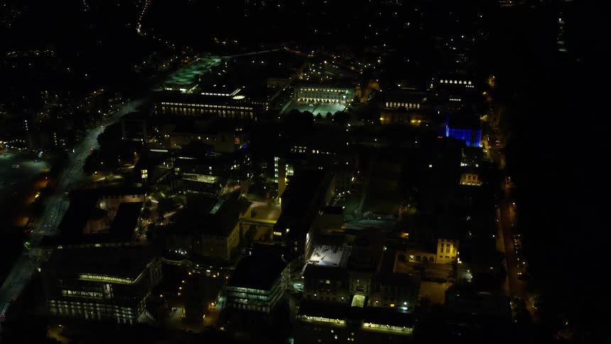Aerial panorama of a metropolis with urban and commercial buildings illuminated at night