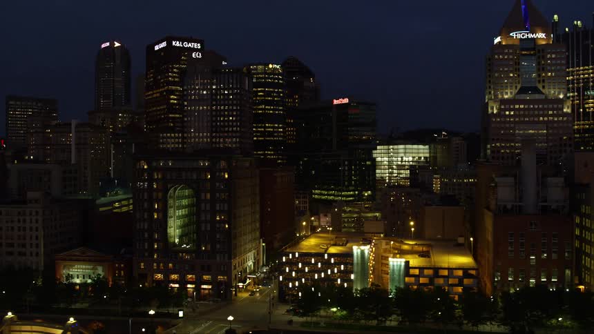 Traffic moves through a city lit up at night