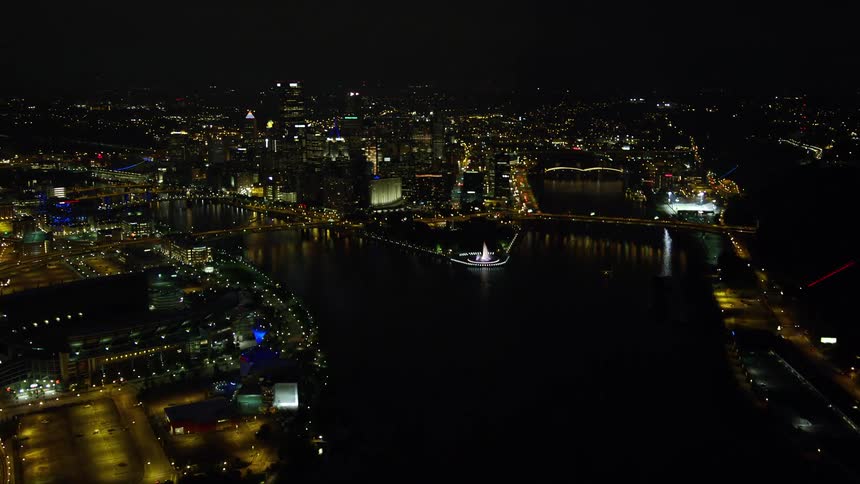 An aerial view of a large city at night with many residential and connected lights