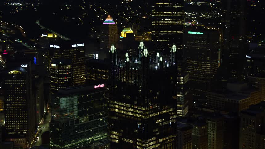 Aerial panorama of a metropolis with skyscrapers modern and mirrored buildings illuminated at night