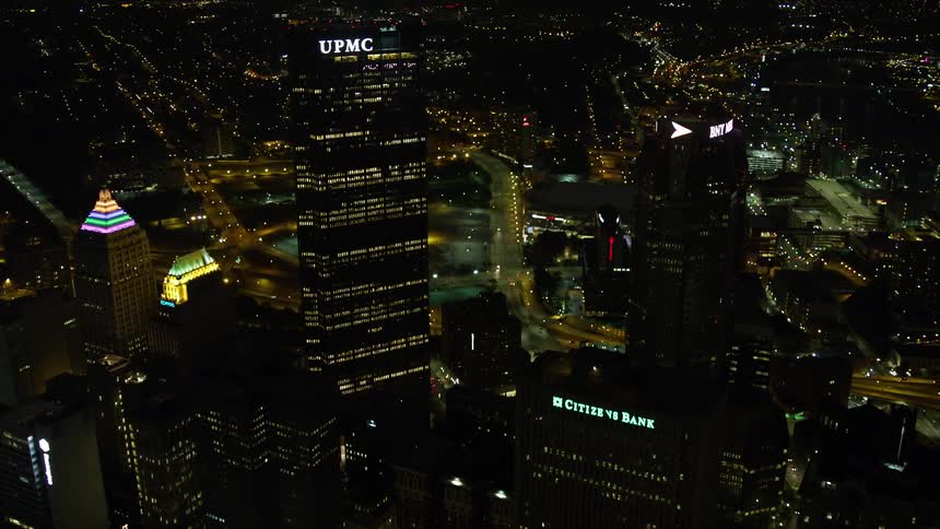 Aerial scenery of a night metropolis with commercial and residential buildings