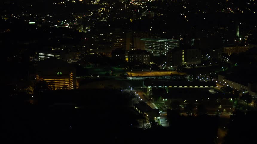 Aerial of an office building complex in a metropolitan area at night