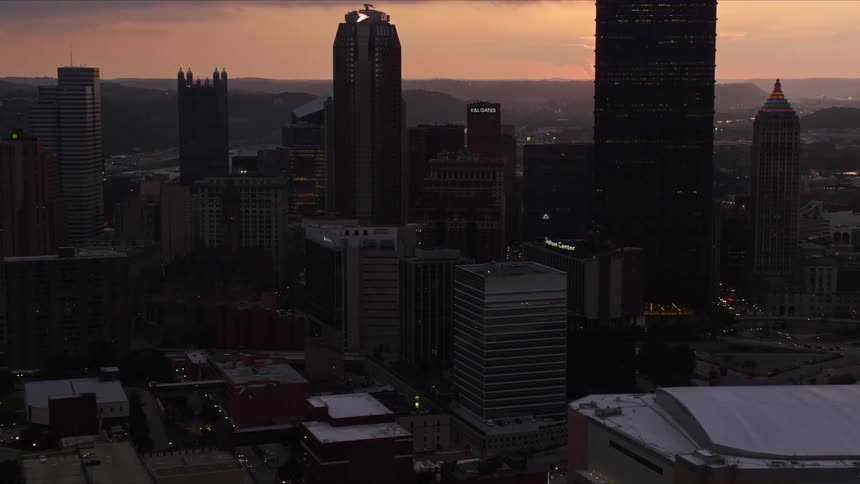 Aerial scenery of skyscrapers in a metropolis with sunset on the horizon