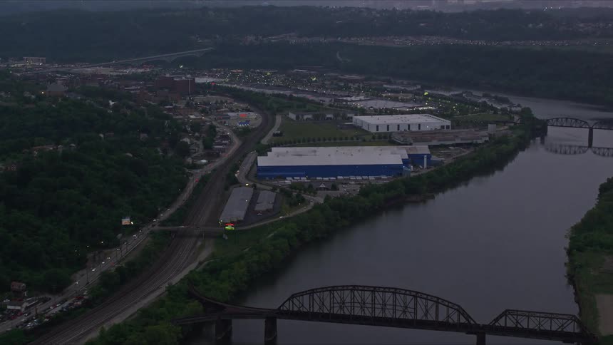 An aerial view of a bridge over a winding river in a city