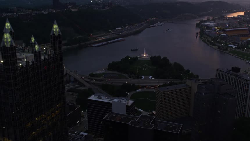Aerial view of a city with a river at sunset