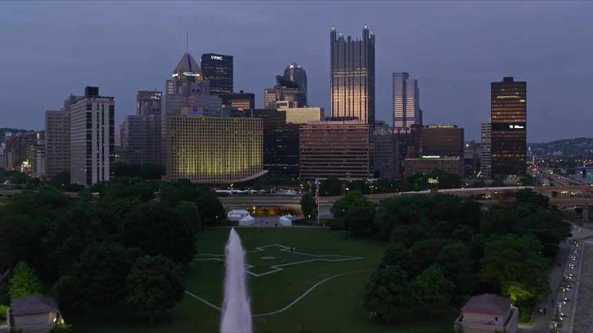 A large fountain is in front of the city