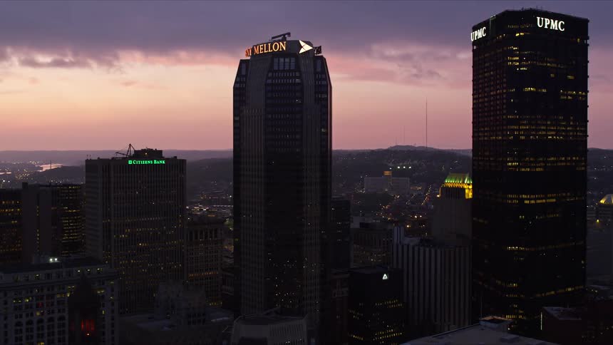 The towers are lit at sunset in the city