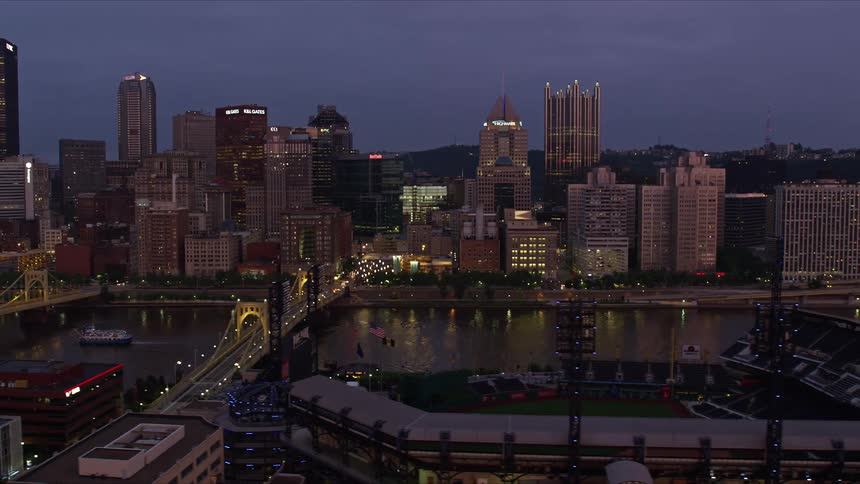 Aerial view of a city with multiple bridges over a river at dusk